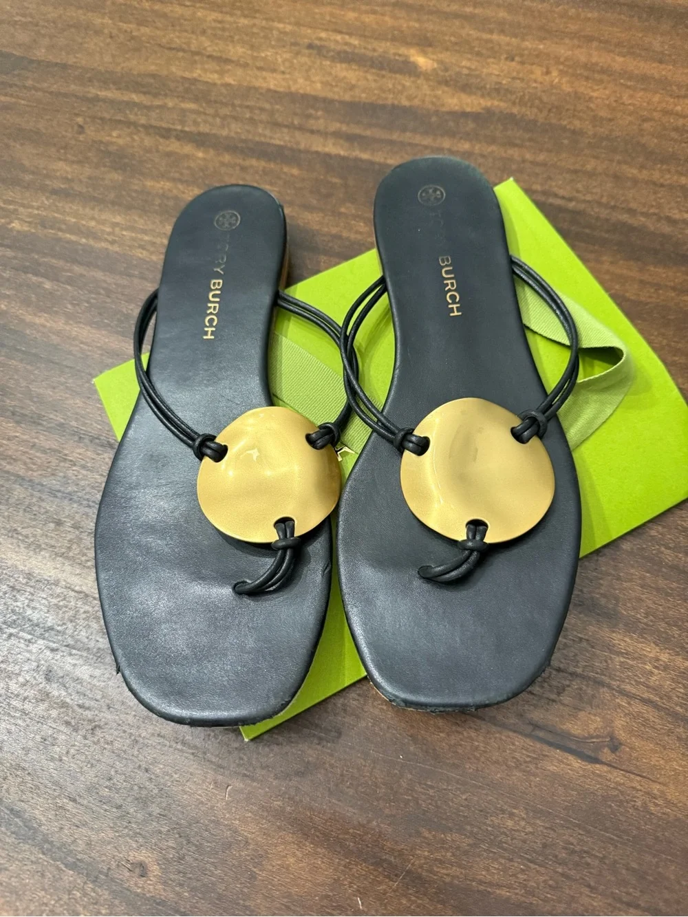 Tory Burch Patos Disk Leather Thong Sandals in black with gold-tone medallions